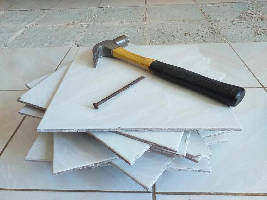 Tiles on top of each other, with a hammer and nail