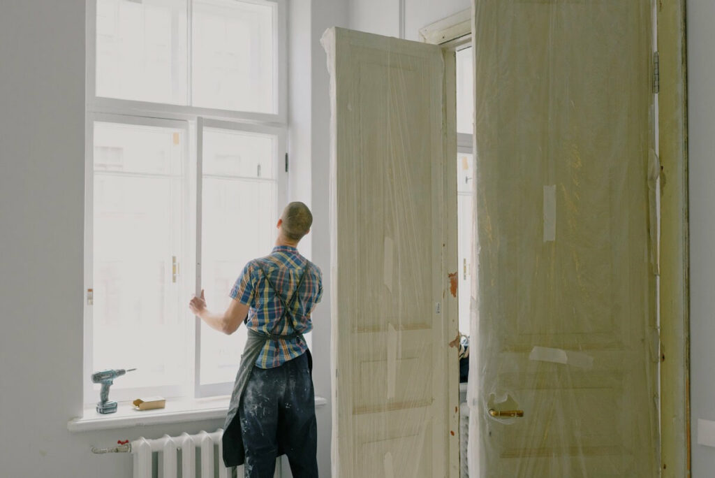 A handyman installing a window