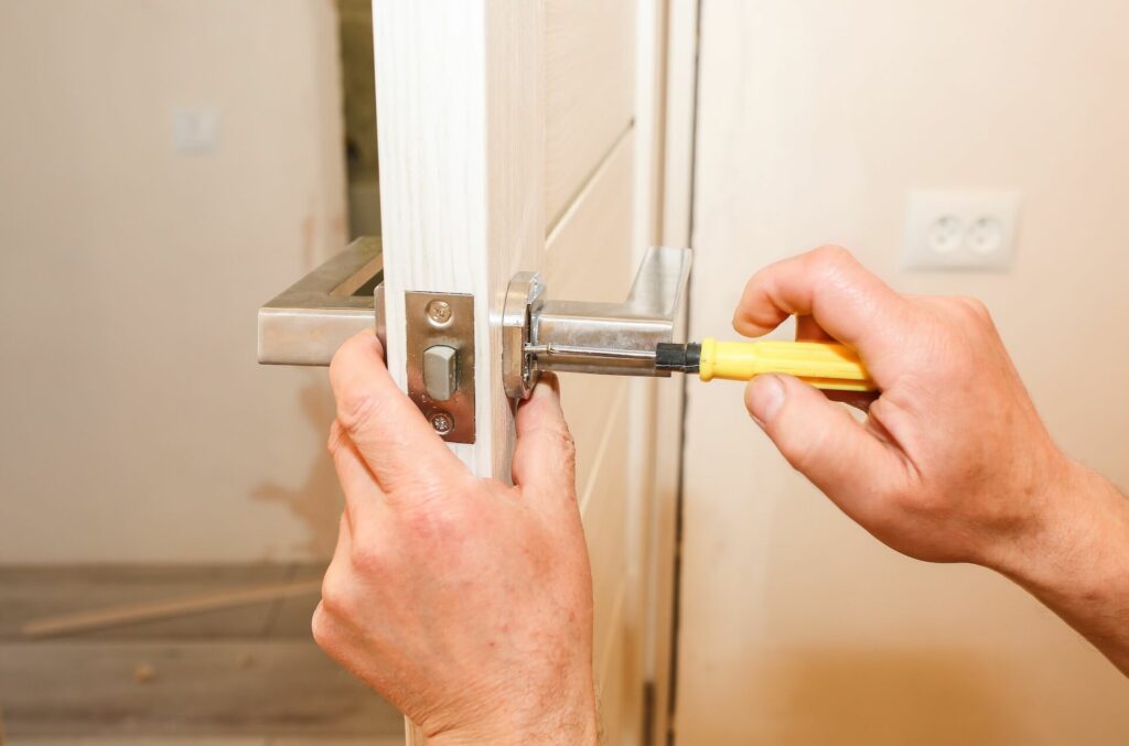 A man installing a door handle