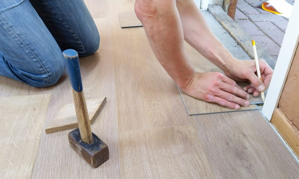 A person measuring flooring